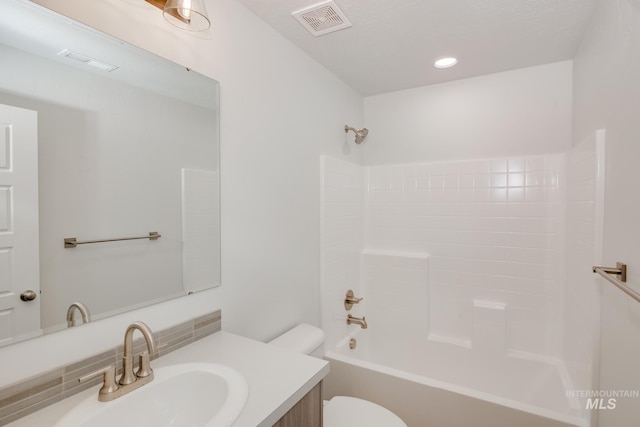 bathroom with toilet, visible vents, shower / washtub combination, and vanity