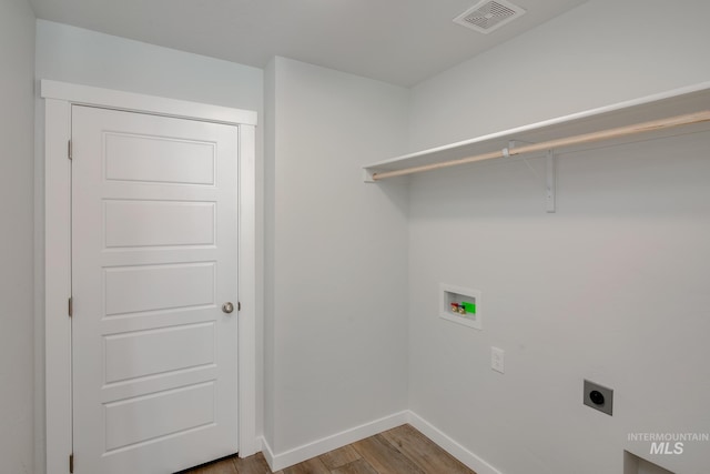 laundry area with hookup for a washing machine, visible vents, electric dryer hookup, wood finished floors, and laundry area