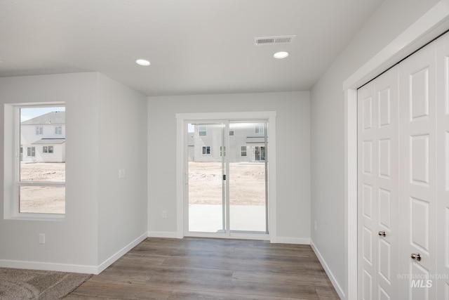 doorway with baseboards, visible vents, and a healthy amount of sunlight