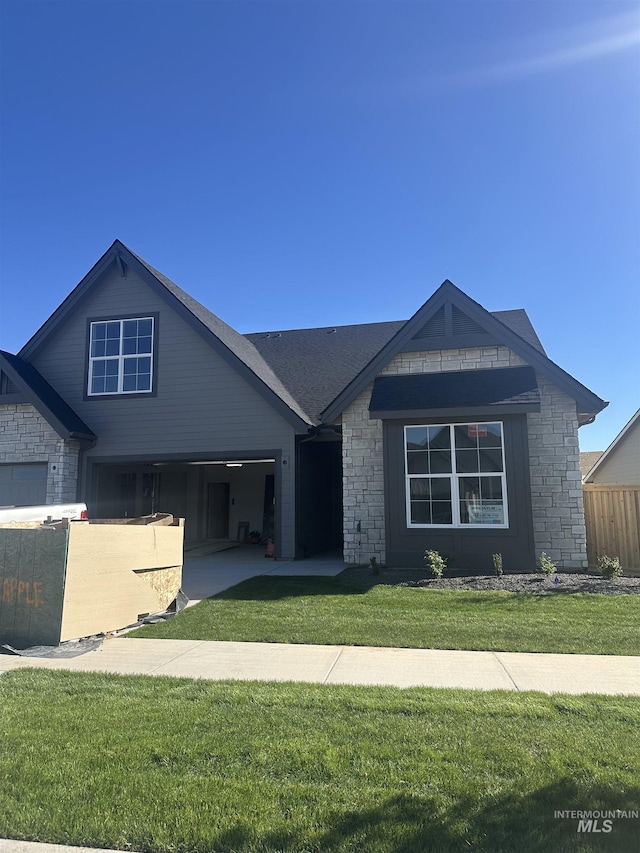4219 W Thornapple Dr, Meridian, ID 83646 - view of front of home with stone siding, a garage, and driveway
