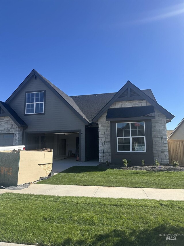 4219 W Thornapple Dr, Meridian, ID 83646 - view of front of home with stone siding, a garage, and driveway