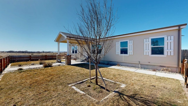 back of property with crawl space, a lawn, entry steps, and fence