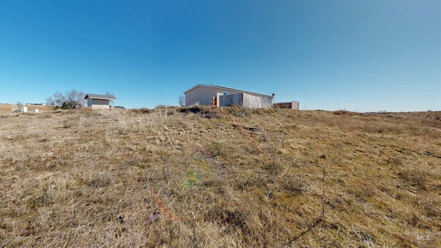 view of yard with a rural view