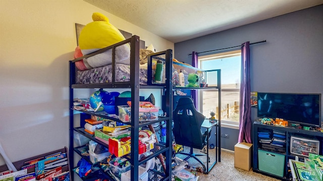 playroom featuring a wealth of natural light, baseboards, a textured ceiling, and carpet flooring