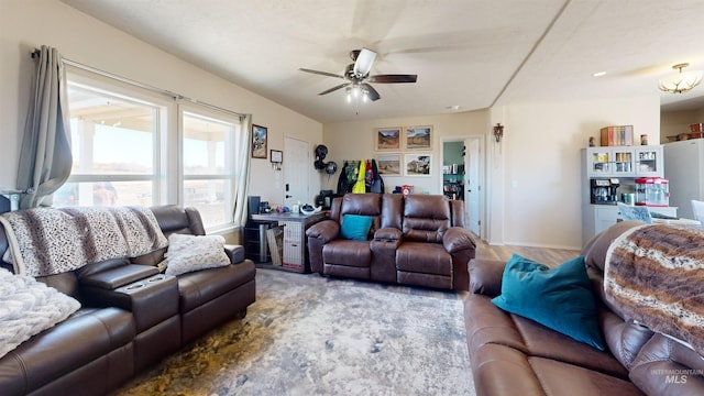 living area featuring baseboards, wood finished floors, and ceiling fan