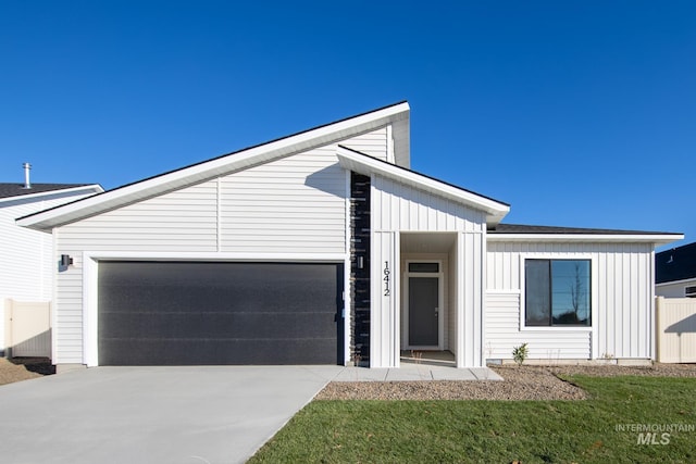 view of front of home with concrete driveway, a garage, and board and batten siding