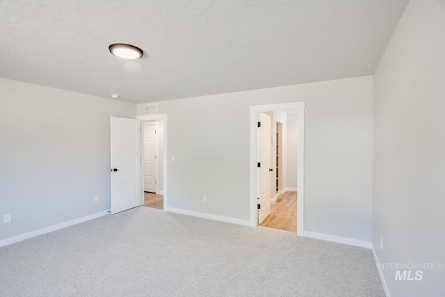 unfurnished bedroom with light carpet and baseboards