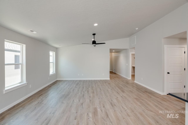 unfurnished living room featuring baseboards, light wood-style floors, visible vents, and ceiling fan