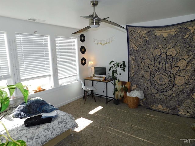 interior space with dark carpet and ceiling fan