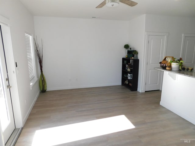 empty room featuring light wood-type flooring and ceiling fan