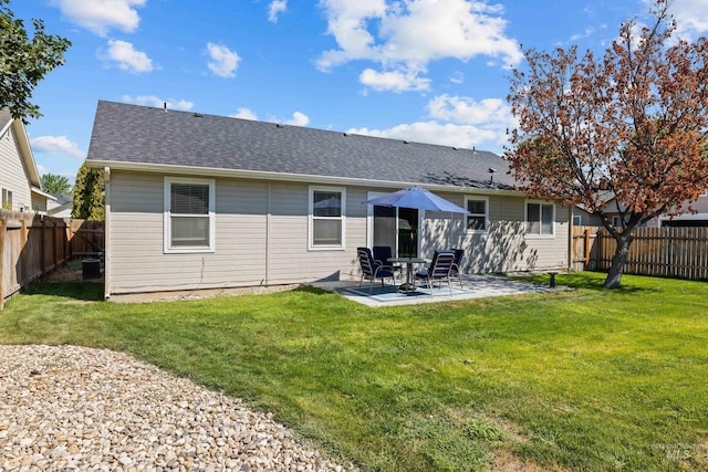 rear view of house with a patio and a lawn