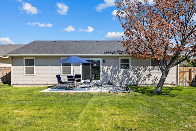 back of house with a yard and a patio