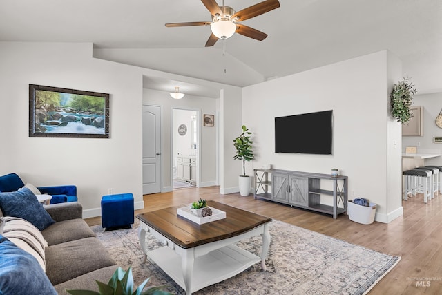 living room featuring lofted ceiling, light hardwood / wood-style flooring, and ceiling fan