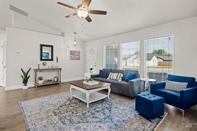 living room with lofted ceiling, wood-type flooring, a textured ceiling, and ceiling fan