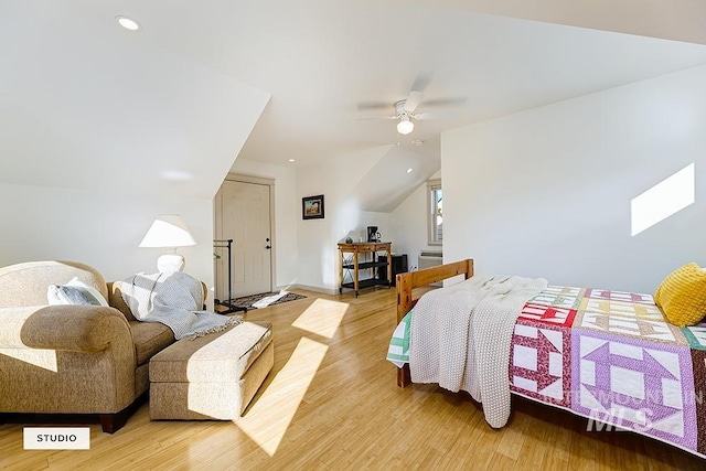 bedroom featuring hardwood / wood-style flooring, ceiling fan, and lofted ceiling