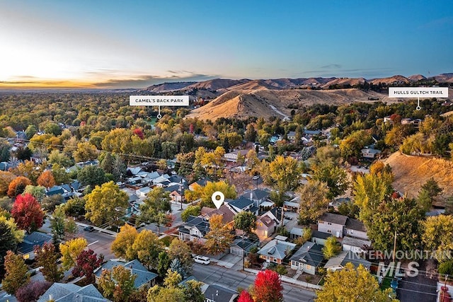 aerial view at dusk featuring a mountain view