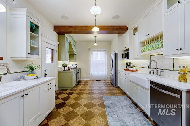 kitchen featuring appliances with stainless steel finishes, decorative light fixtures, beam ceiling, and white cabinets