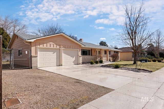 single story home featuring driveway, a gate, fence, an attached garage, and brick siding