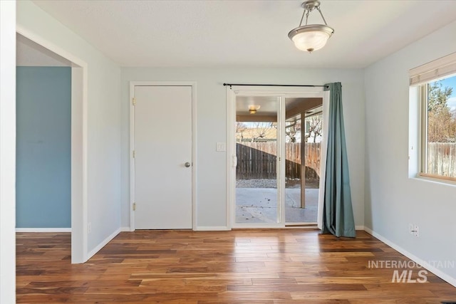 interior space featuring baseboards and wood finished floors