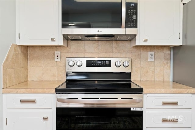 kitchen with stainless steel appliances, white cabinetry, tasteful backsplash, and light countertops