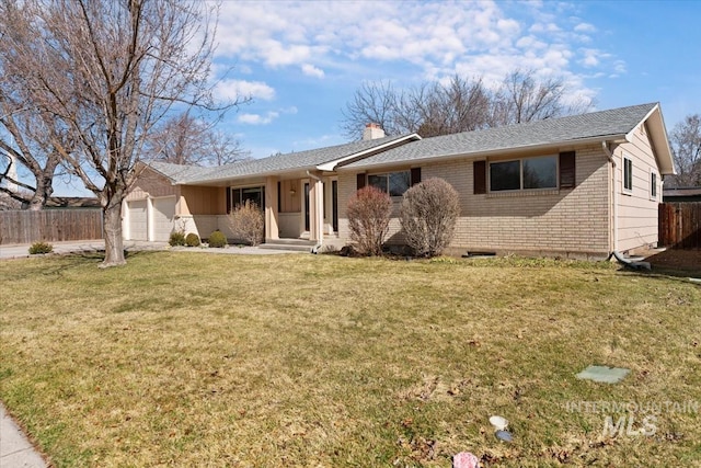 ranch-style home with fence, an attached garage, a chimney, a front lawn, and brick siding