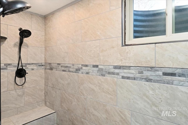 bathroom with a tile shower