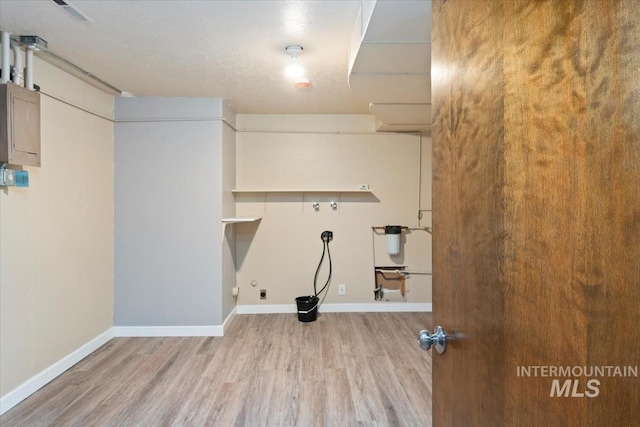 laundry room featuring hookup for a washing machine, wood finished floors, baseboards, laundry area, and electric panel