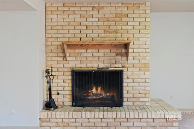 interior details with a brick fireplace