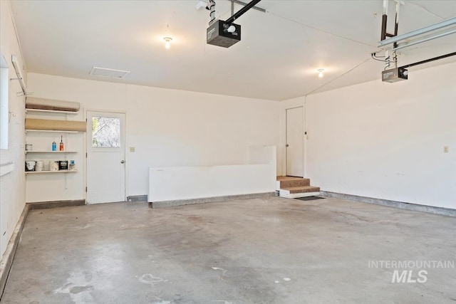 garage featuring a garage door opener and baseboards