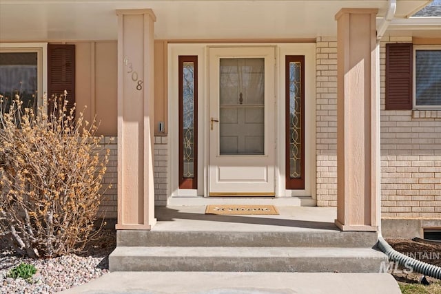 property entrance featuring brick siding