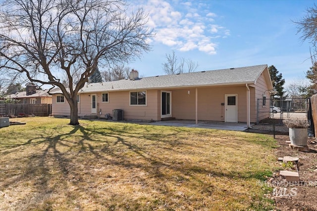 back of property with a patio, fence, a yard, a chimney, and central air condition unit