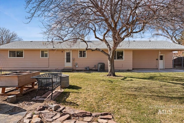 back of house with a patio, fence, entry steps, central air condition unit, and a lawn