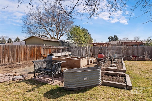 view of yard featuring a vegetable garden and fence