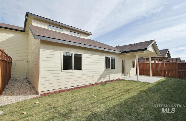 rear view of house with a lawn and a patio area