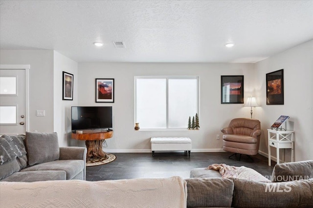 403 Antonette Cir, Cascade, ID 83611 - living room featuring dark wood-style flooring, baseboards, and recessed lighting