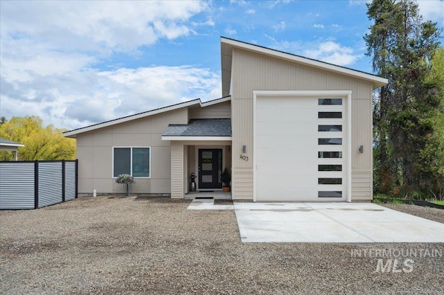 403 Antonette Cir, Cascade, ID 83611 - contemporary house featuring concrete driveway, an attached garage, and a shingled roof