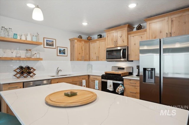 403 Antonette Cir, Cascade, ID 83611 - kitchen with stainless steel appliances, a sink, light brown cabinetry, tasteful backsplash, and recessed lighting