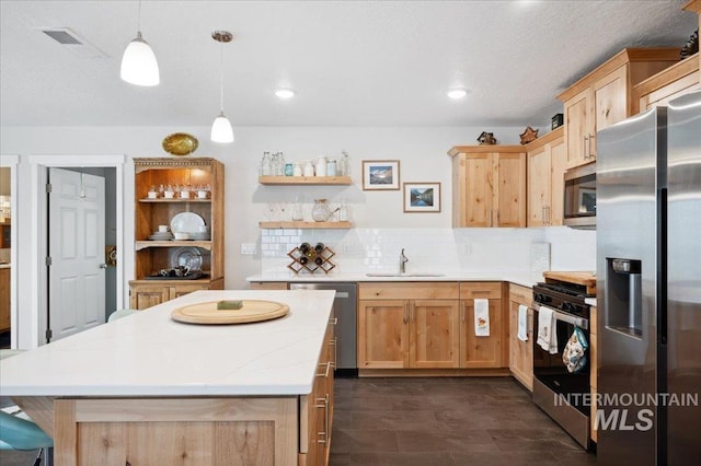 403 Antonette Cir, Cascade, ID 83611 - kitchen featuring appliances with stainless steel finishes, light brown cabinets, open shelves, a sink, and recessed lighting