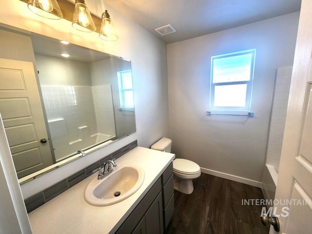 bathroom featuring hardwood / wood-style floors, vanity, and toilet