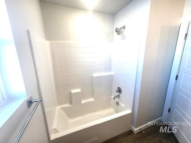 bathroom with wood-type flooring and shower / bath combination