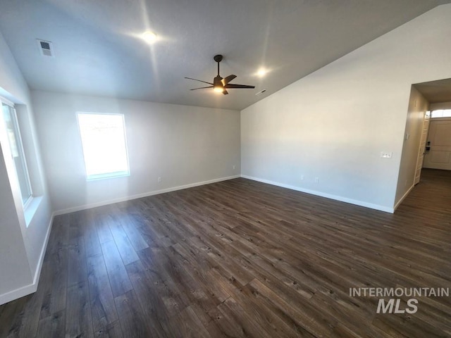 spare room with ceiling fan, dark hardwood / wood-style flooring, and vaulted ceiling