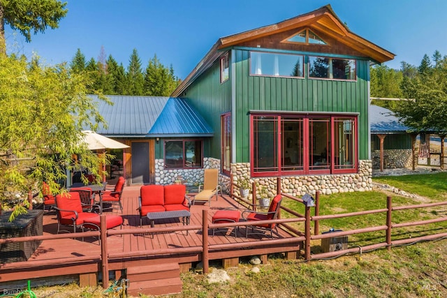 back of property with outdoor lounge area, a lawn, and a wooden deck