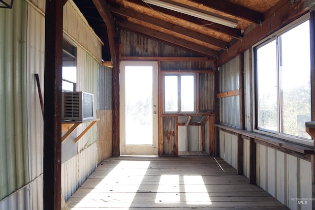 interior space with a wealth of natural light, cooling unit, and vaulted ceiling with beams