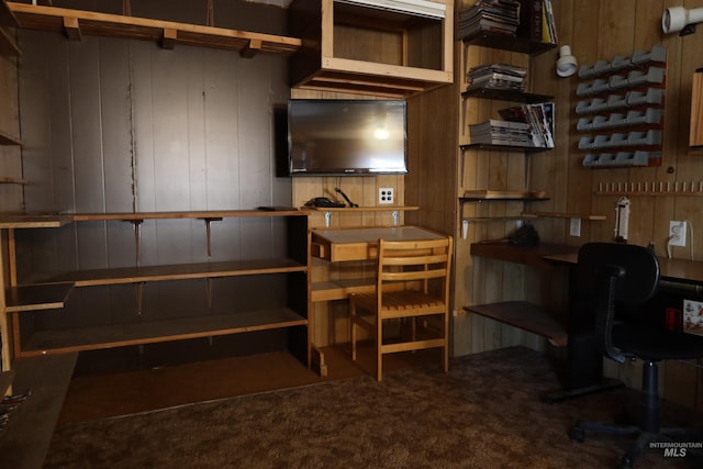 home office featuring carpet and wooden walls