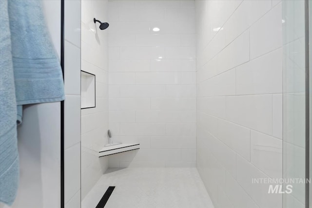 bathroom with tiled shower