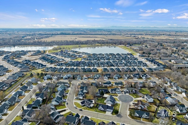 bird's eye view featuring a water view and a residential view