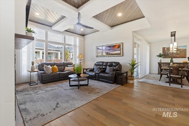 living room featuring ceiling fan, recessed lighting, coffered ceiling, wood finished floors, and beam ceiling