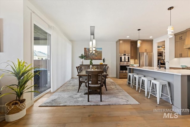 dining area with recessed lighting and light wood-style flooring