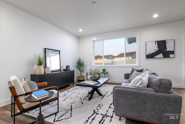 living area with wood finished floors and baseboards