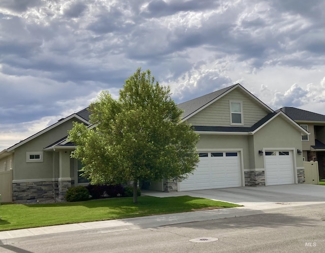 1983 Prospector Way, Twin Falls, ID 83301 - view of front of home with stone siding, stucco siding, concrete driveway, and a front yard